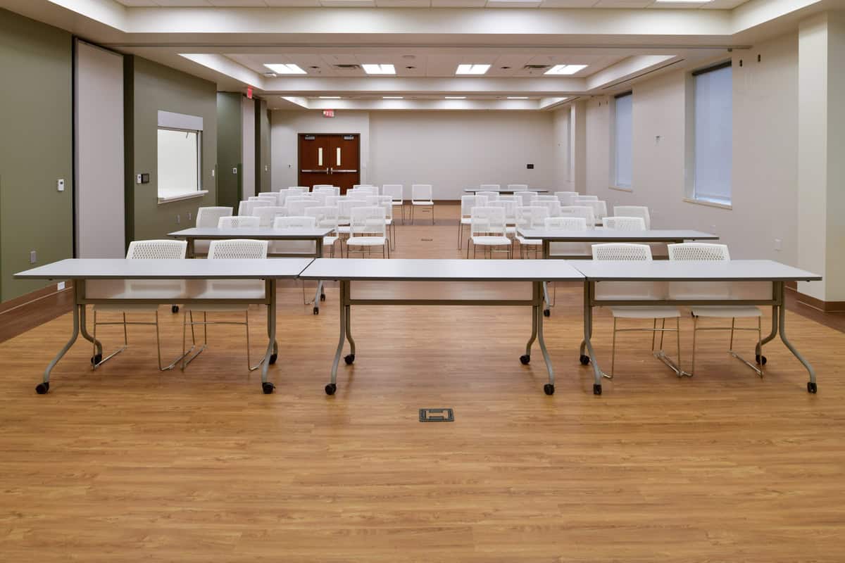 Tables and chairs inside conference room.