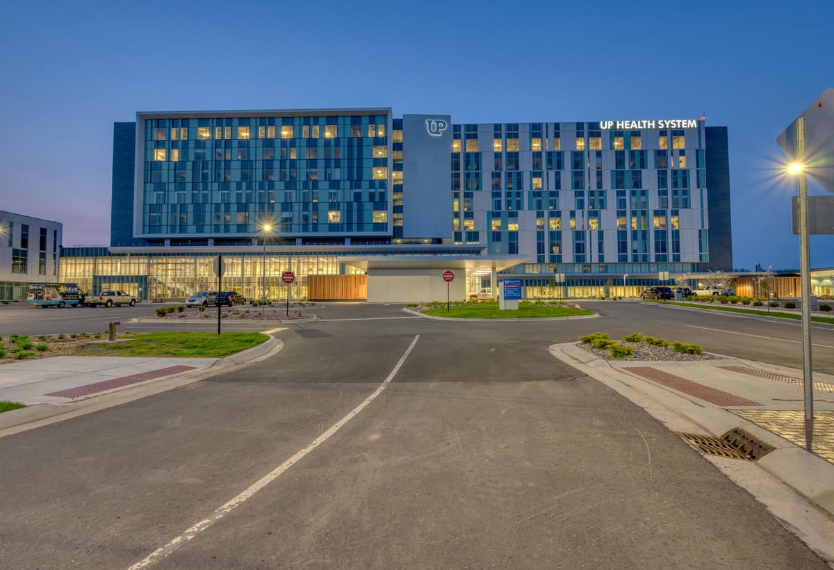 Marquette Hospital as viewed from street in the evening.